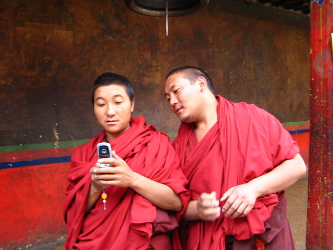 Monks at Tashilhunpo looking at pictures on their cell phone, especially the risque pictures of one of the team members.